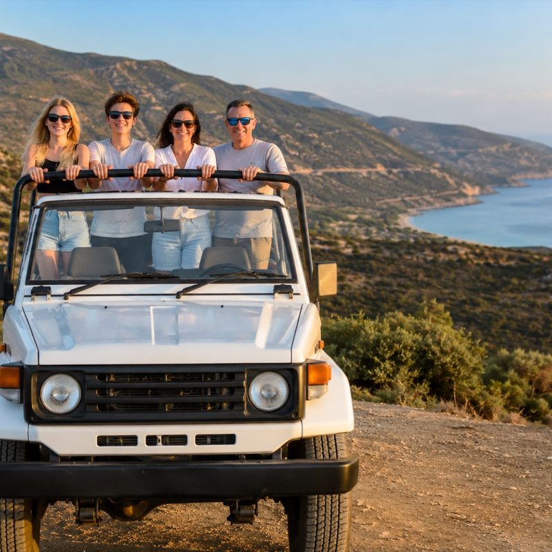 Safari jeep with smiling passengers at a viewpoint above Chrysochou Bay near the Baths of Aphrodite