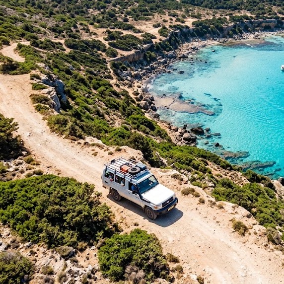 Blue Lagoon turquoise bay from above with a safari jeep on the coastal track