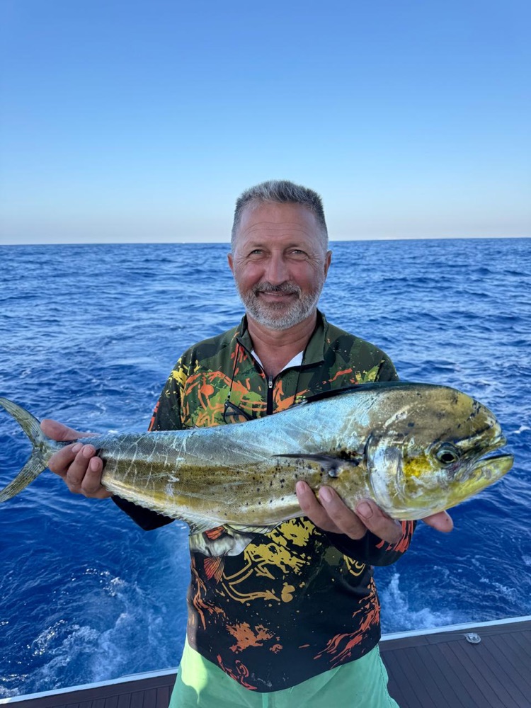 Guest holding a mahi-mahi caught off Limassol