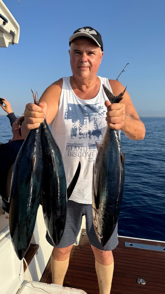 Guest holding two fish caught off Limassol